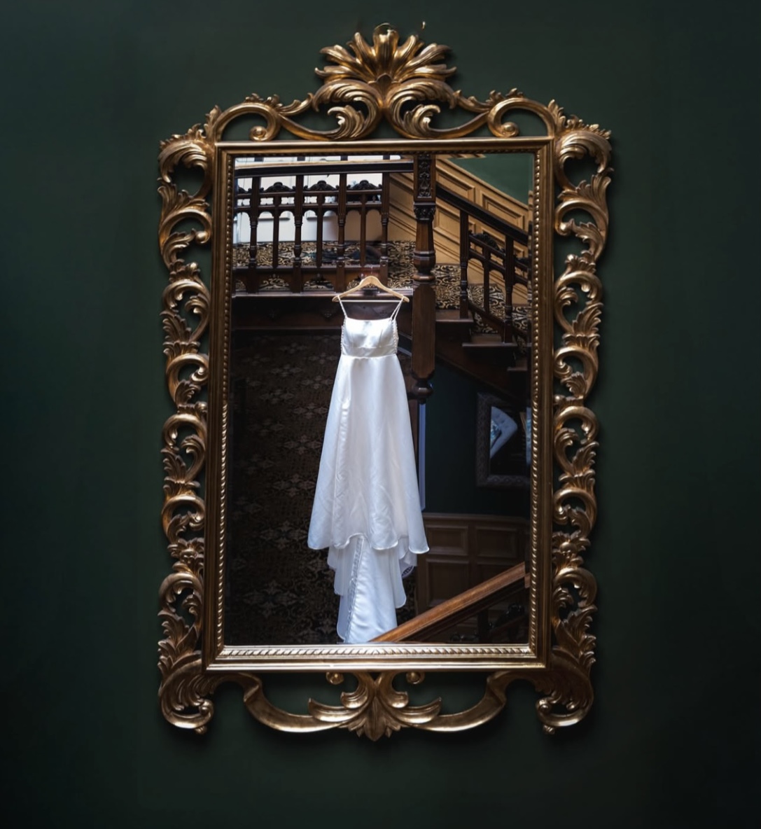 Wedding Dress hanging in front of mirror. Stone House Hotel, weddings